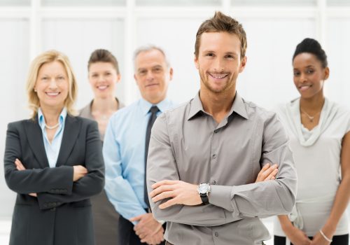 Portrait Of Young Businessman With Business Team